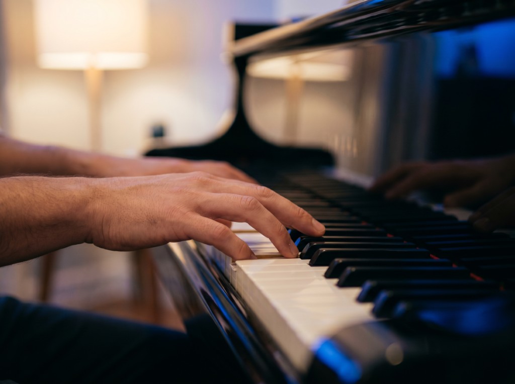 Close-up of hands playing piano keys